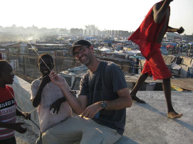 Dave flying kites with children living in tent cities in Haiti after the quake there last winter.  Dave will move to Connecticut this summer.