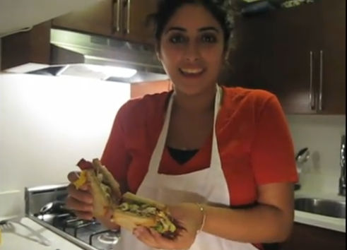 THE MAMACITA LILI SANDWICH:  Jasmine Einalhori named her prizewinning entry after her mom, Registrar and Facilities Director Lili Einalhori. Seen here in a snapshot for her video contest entry on YouTube, the sandwich is made of fried egg, fried pastrami and guacamole. Video by Molly Keene, BP Emeritus