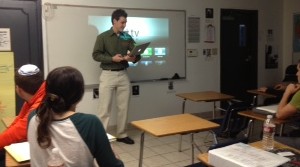 HIGH TECH: AP Government teacher Mr. William Reusch prepares to post a PowerPoint on the white board in Room 2, connected by Apple TV. Connectivity has been a problem, but most students and teachers like the equipment when its working. BP Photo By Emilie Benyowitz 