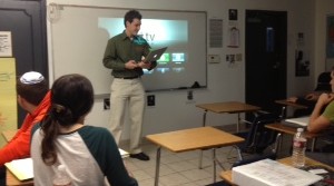 HIGH TECH: AP Government teacher Mr. William Reusch prepares to post a PowerPoint on the white board in Room 2, connected by Apple TV. Connectivity has been a problem, but most students and teachers like the equipment when it's working. BP Photo By Emilie Benyowitz 