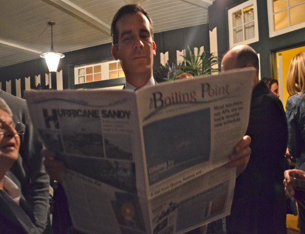 RUNOFF: Eric Garcetti, candidate for mayor, reading The Boiling Point at a private fundraiser in Hancock Park in March. Election Day is next Tuesday.
