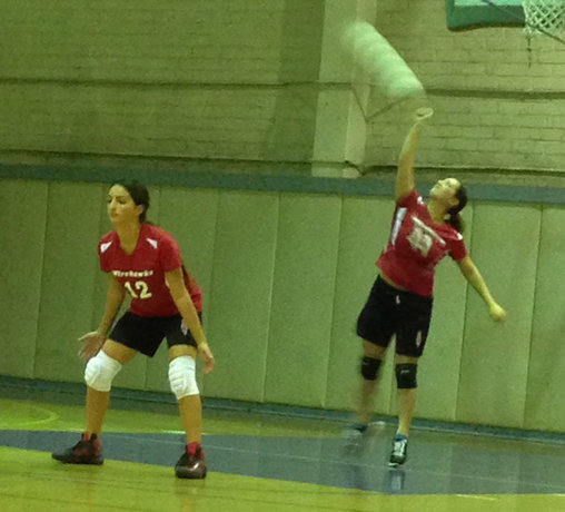 ROCKET: Senior Tamar Willis #11 serves the ball as freshman Dana Alkoby #12 waits, down and ready.  The Firehawks lost to YULA 3-0 on Tuesday, Oct. 29.