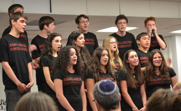 CHANGE: Wearing custom t-shirts, the Choirhawks performed Ingrid Michaelson’s hit “The Way I Am” at their concert June 9. The group has added more pop, along with beat-boxing by Jake Benyowitz (at top right, above), to its song list.