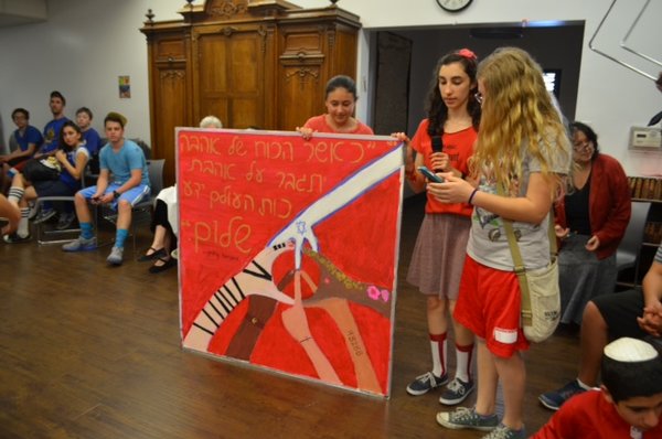 SHALOM:  The Red Team, whose theme was shalom (peace), presents its winning banner, designed by Rachel Spronz, Eliana Hjortzberg Litov and Sarit Ashkenazi.  