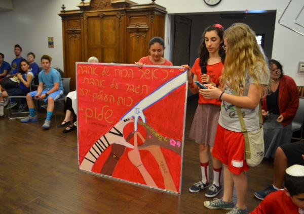 SHALOM:  The Red Team, whose theme was shalom (peace), presents its winning banner, designed by Rachel Spronz, Eliana Hjortzberg Litov and Sarit Ashkenazi.  