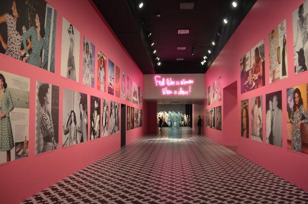 CLASSIC: A bubblegum-pink hallway studded with blown-up photos of Diane von Furstenberg and women in her signature wrap dresses greets visitors to LACMA West’s free exhibit.  The Journey of a Dress will be open until April 1.