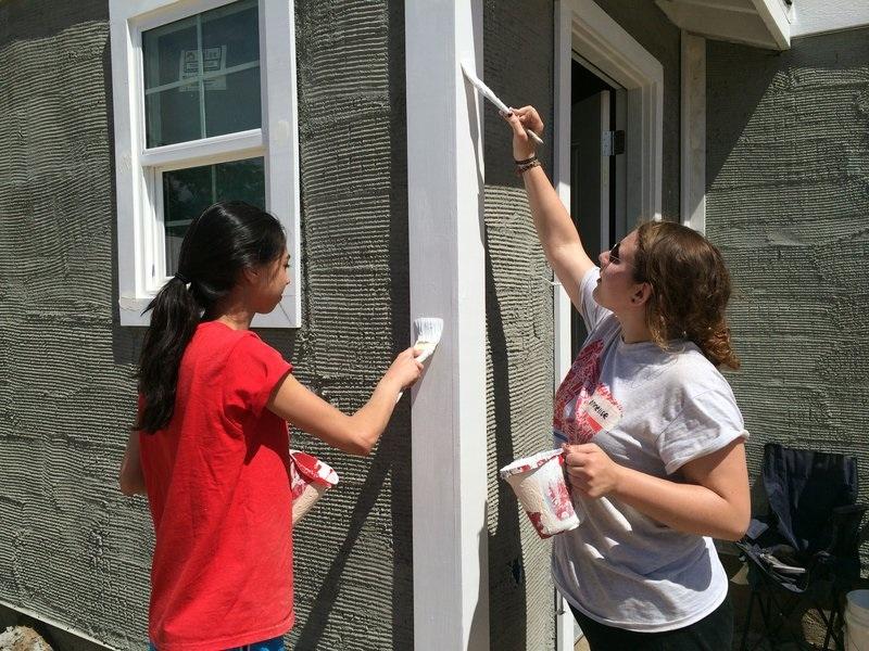 CHESED: Seniors Sarah Soroudi and Annie Asch paint a Habitat house last month.