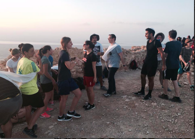 SUNRISE: With Rabbi Segal at center, members of the class of 2014 look out over the Negev from the top of Masada, which they had climbed before dawn.