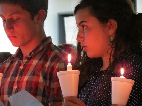 MEMORIAL: Freshmen Nathan Benyowitz and Tania Bohbot read names of child victims at ceremony in Beit Midrash.
