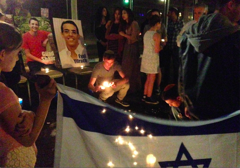 VIGIL: Teens positioned candles on Pico Boulevard July 1 after a commemorative service at Beth Jacob. 