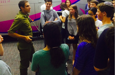 REST: An IDF soldier on leave from the fighting in Gaza addressed Bnai Akiva students in Jerusalem July 22.