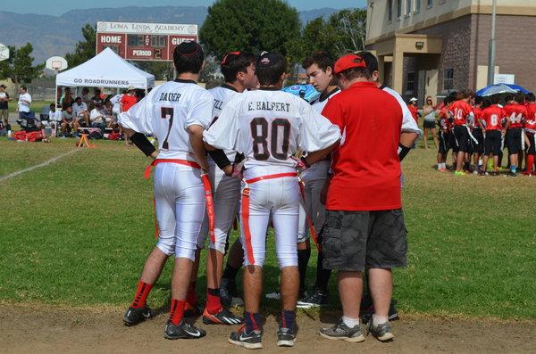 HUDDLE: During a timeout, the Firehawks huddle around Coach Buckley.