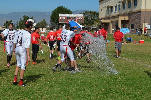 SPLASH: Captains Mati Hurwitz and Adam Kaufler shower Coach Buckley after win over Escondido. 