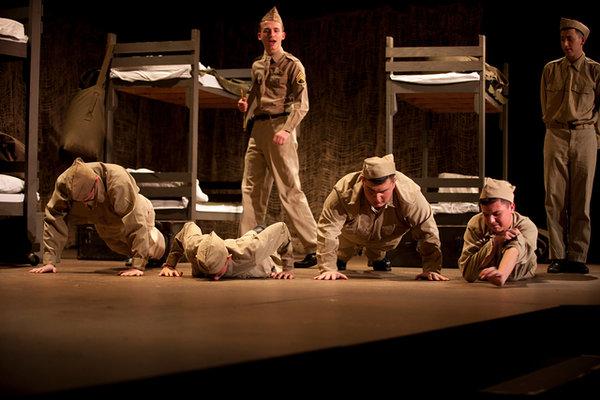 Senior David Lorrell as Sgt. Toomey assigns push-ups to discipline recruits in the World War II-era drama Biloxi Blues. Freshmen missed the preview because of a bus problem.
