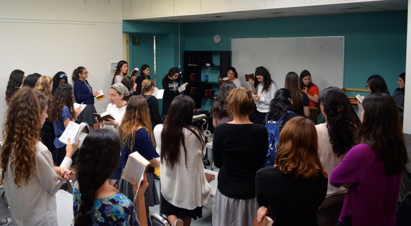 SING: Students gather daily for the girls-only singing minyan. The minyan is the largest attended at school with 59 girls.