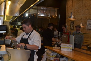 RESTAURANT: Mexikosher chef Katsuji Tanabe prepares food behind the counter for waiting customers. 