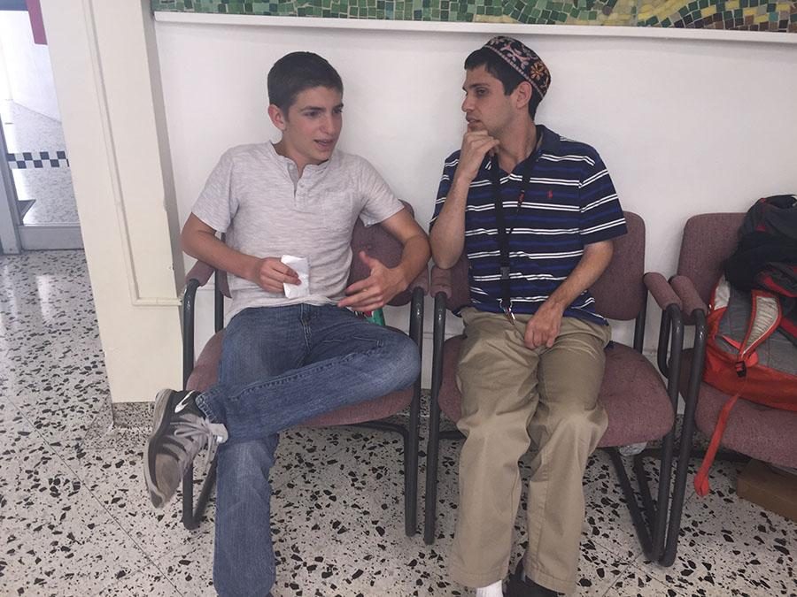 HELPFUL: Daniel Schwartz converses with sophomore Ephraim Drucker in the JCC foyer. 