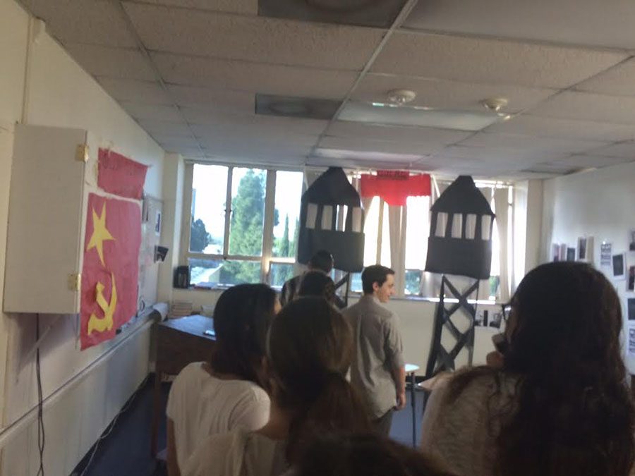 MEMORIES: Above, students explore Soviet-themed decor in Ms. Malikov’s math classroom April 1. Guard towers and the Soviet flag were supposed to be a tribute, but brought back terrible memories for the teacher