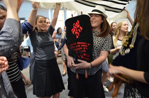 DANCE: Students celebrate with new Torah donated by Stacey Kent (center) and family after watching scribe Ronnie Siegar pen the last three words.