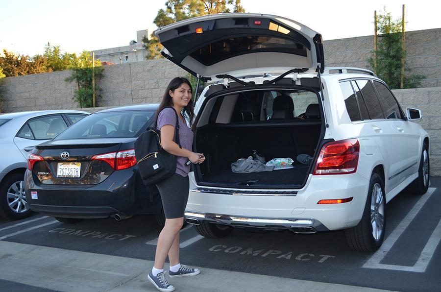 WINNER: Senior Nicole Newman poses next to her prize, a spot for a month in the on-campus staff parking lot.