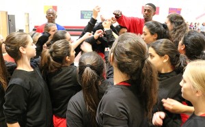 girls basketball team shared a cheer with Coach Flava before their first game at the Glouberman Tournament Nov. 12.