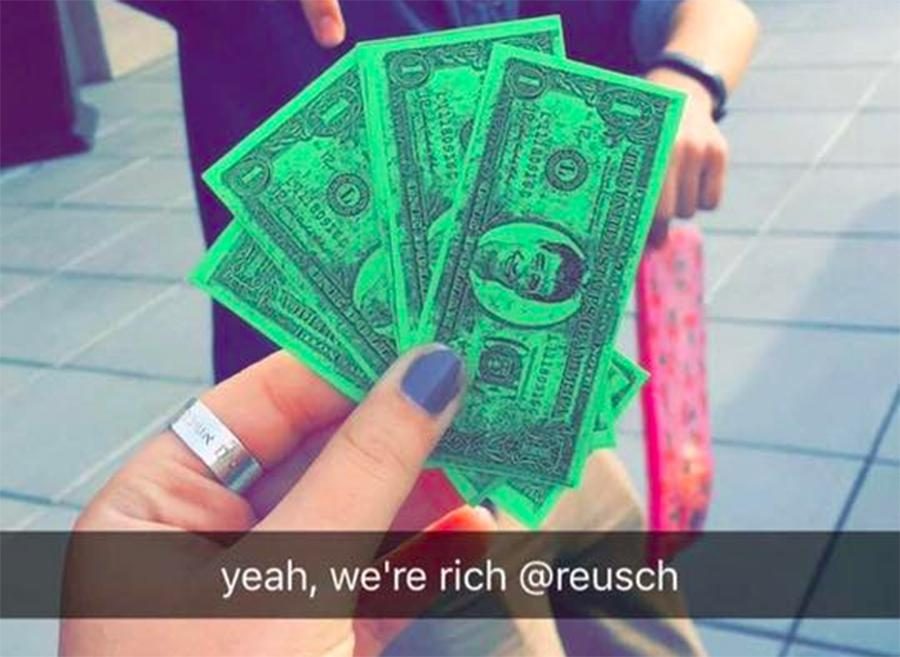 UNEVEN%3A+Junior+Sarit+Ashkenazi+admires+her+Reuschbucks+on+Snapchat+last+month.+Students+worked+toward+the+same+goal%2C+but+some+started+with+only+a+few+dollars+while+others+were+given+many.