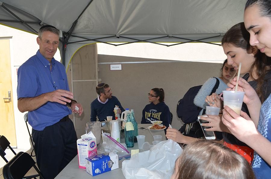 OPEN: Dr. Amit served coffee to students in an open sided tent on the rooftop turf during his two-week residency in February. 