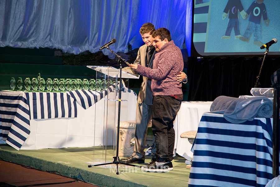 IMPROVISED: In the middle of his acceptance speech, Yaakov had his friend, nicknamed Sam (right), join him on stage. Yaakov and Sam, who has autism, have been friends for many years.
