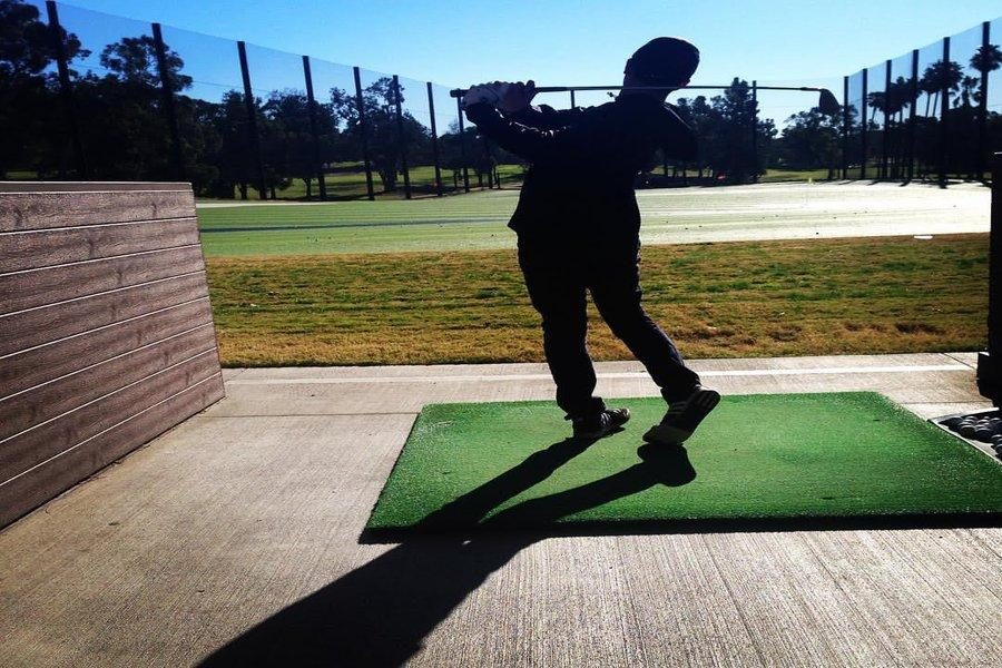 DRIVE: Freshman Michael Soussana takes a shot at the driving range where the golf team practices.