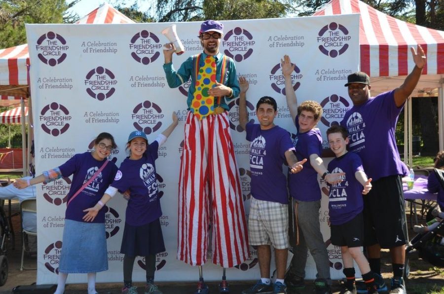 FESTIVE: Friendship Circle staff and volunteers pose with a clown at last year’s Walk4Friendship Carnival at Rancho Park. This year, the carnival will take place in the Shalhevet Parking lot.