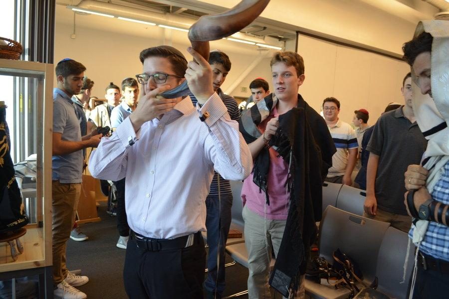 BLAST: Rabbi Block blows the shofar during Hashkama minyan, a reminder to the students about the importance of listening. 