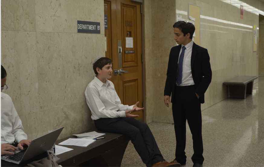 COURTHOUSE: Lawyer Zack Hirschhorn practices his direct examination of witness Nicholas Fields in a hallway outside of the Criminal Court Building downtown in the third round of the competition. 