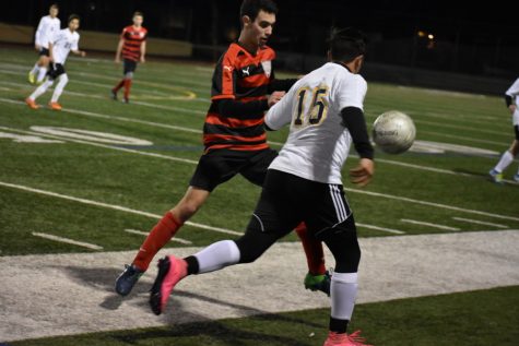 SCRAMBLE: Firehawk junior Isaac Kahtan fights YULA No. 15 for the ball at rivalry game in Encino Jan. 14.