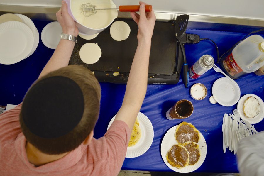 SIZZLE: Senior Ephraim Drucker and business partner Ben Harel (not pictured), also knows as The Pancake Boys, make pancakes from scratch. 