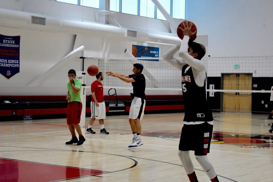 PRACTICE: Shalhevet’s Zach Muller passed to a teammate as the Firehawks practiced throughout the summer.
