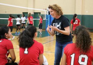 PEP TALK: Volleyball coach Ms. Marla Weiss offers pointers to her players during a game against Ambassador High School in the gym Oct. 17.