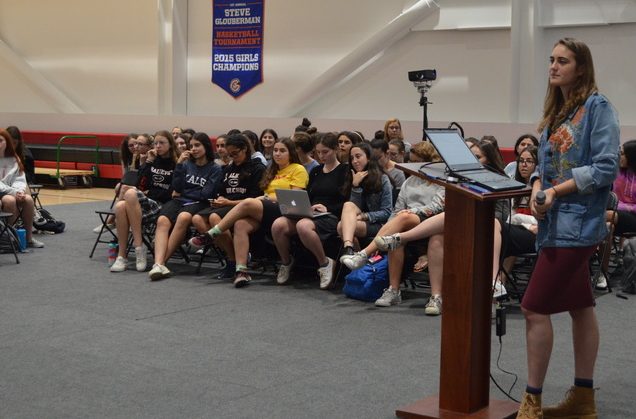 SPLIT: Senior Rosie Wolkind led the girls portion of Town Hall Oct. 19. Students were divided by gender for the first half of the meeting