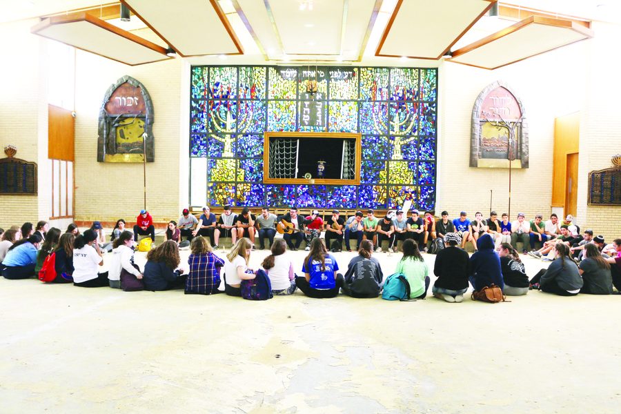 The class of 2019 hears from the rabbi in the gutted sanctuary of United Orthodox Synagogue.