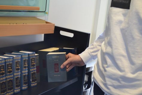 PRAYERS: Every morning and afternoon Shalhevet students pick up a new Koren-Sacks siddur for prayer services.
