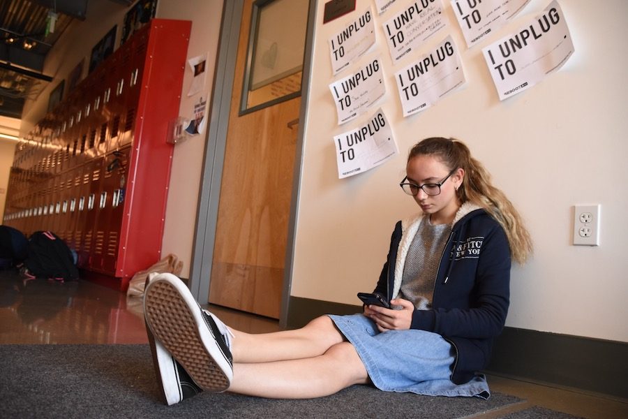 PHONE: Sophomore Shayna Schusterman shows social media is still alive and well in the second floor hallway. But some are opting in to get off of social media for while.
