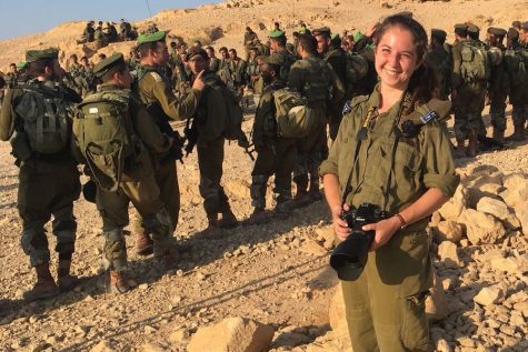 BERETS:   IDF Private Rachel Lester, Shalhevet class of 2012, posed with her camera at sunrise at the end of the Nahal Beret March last summer. The recruits later received their green berets.  Photo by Samantha Sharpe. 