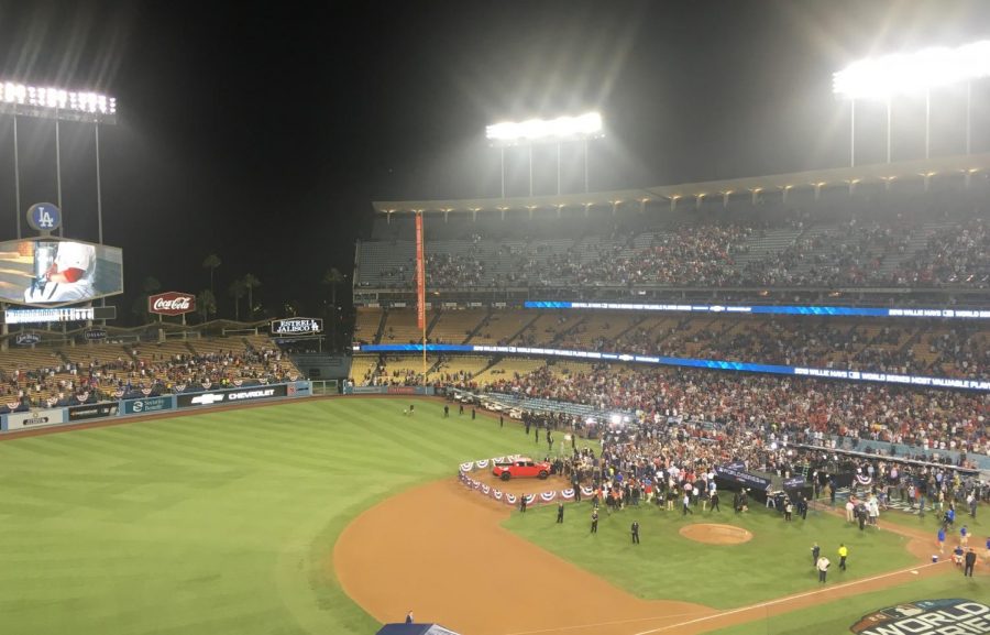 AFTERMATH:    Red Sox players meet the news media in Dodger Stadium after winning the World Series four games to one  Oct. 29.  The stands above them, which had been a sea of blue and white, had mostly emptied out -- except for Boston fans, dressed in red.