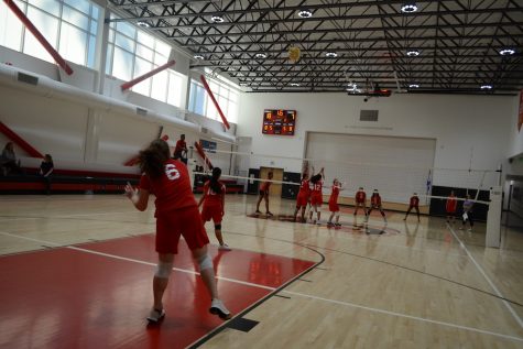 SERVE:    Freshman Jessica Melamed starts a play as her teammates get into position during the Firehawks’ victory over Wish Charter in the gym Oct. 18.
