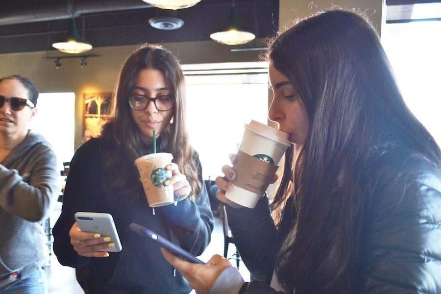 CLOSE:   Starbucks and Coffee Bean are frequented by Shalhevet students throughout the day. Above, juniors Celine Basiratmand (center) and Maital Hiller drank coffee during breakfast Feb 15. 
