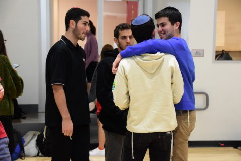 CHANGES:    Then-juniors Eitan Remer (third from left) and Jonathan Fishman (fourth from left) wrote a proposal last year that allowed boys to wear non-collared shirts provided they are wearing tzitzit that are visible. Rabbi Schwarzberg says boys have not been following this rule.