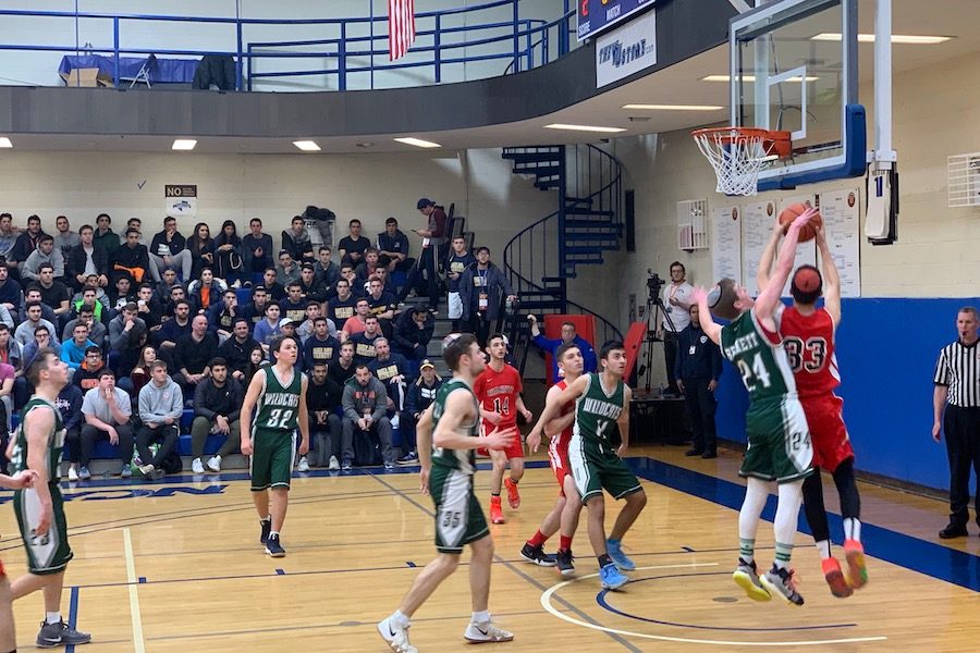 ATTACK:    ATTACK: Firehawk forward and Sarachek MVP Asher Dauer goes for a lay-up as junior A.J. Bennett tries to block it in the Firehawks’ 60-41 win over the DRS Wildcats Mar. 17. The Firehawks became only the second team ever to win YU’s Sarachek tournament two years in a row. 