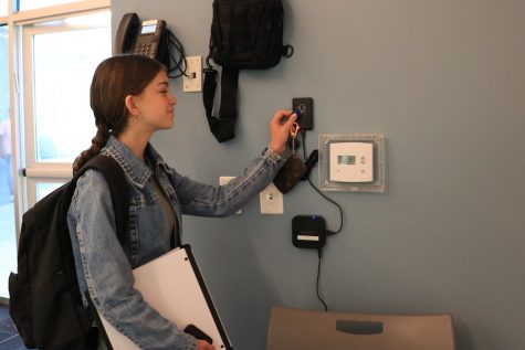 MORNING: Freshman Madeleine Bollag scans in to the main minyan at Shacharit during the second week of school. The fob, which she carries on her key chain, transmits her identity to a computer program that takes attendance and shares the information with teachers who need to know.