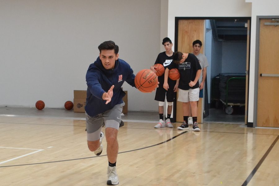 PRACTICE:   New JV boys coach Alex Plax leads a drill during practice on Sept. 24 Coach Ryan Coleman will be taking over the varsity basketball program this year, while Athletic Coordinator Coach Jeff Remer will have oversight on the JV program.