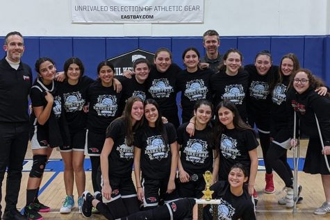 CHAMPIONS:  The Firehawk girls take a team photo with their championship trophy after beating Notre Dame 60-48 Dec. 12. After making some halftime adjustments, the Firehawks played an explosive second half to power to a comfortable victory.
