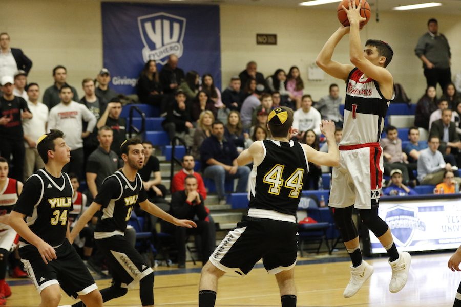 HIGHLIGHT: Attending the annual Red Sarachek Tournament is a big event not only for Shalhevet players but for their fans, many of whom fly to New York for the event.&nbsp; Above, Firehawk then-captain and MVP Zack Muller leapt over rival YULA players in YU’s Max Stern Athletic Center in 2018.